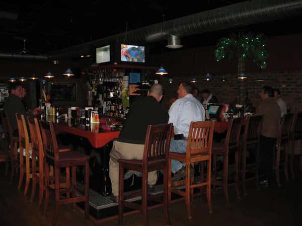 two men sitting at the bar