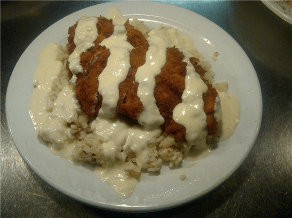 entree over rice on a plate