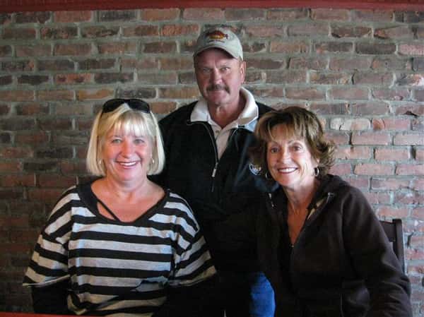 three people posing for picture