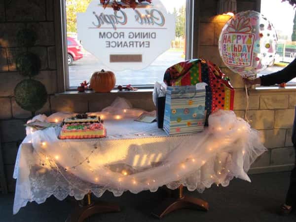 table decorated for a birthday party with a birthday cake and balloon