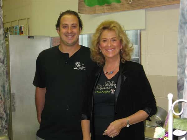 two employees posing for picture