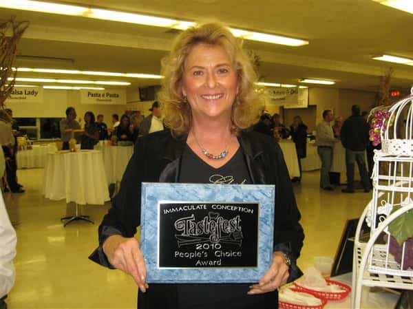 female smiling holding plaque