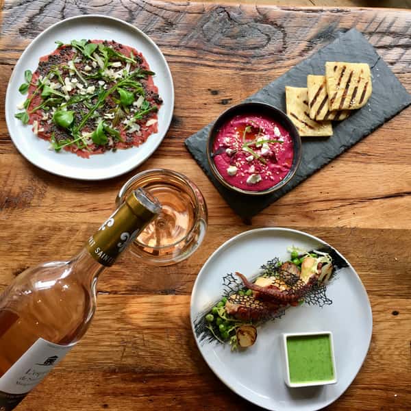 A beautifully plated dish featuring Provençal cuisine at St Tropez Wine Bar.