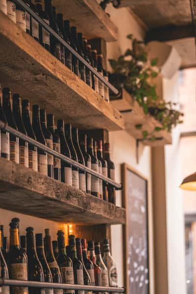 Selection of fine wines displayed on shelves at St Tropez Wine Bar.
