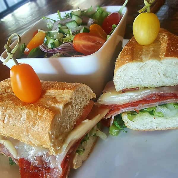 italian sub with tomatoes and a side salad