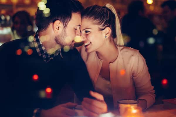 Man and woman smiling at each other at dinner