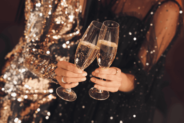 Two people doing a champagne toast