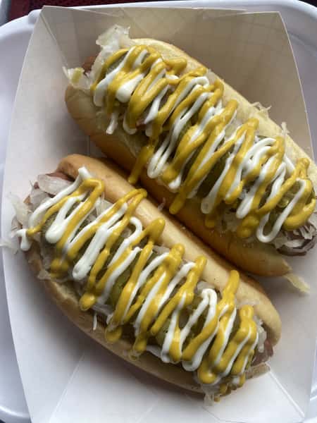 2 Hot dogs with mustard and mayo on it