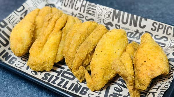 Golden brown fried fish fillets arranged on white paper with black lettering.