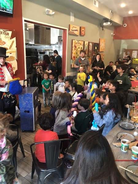 group of children and parents watching a magic show