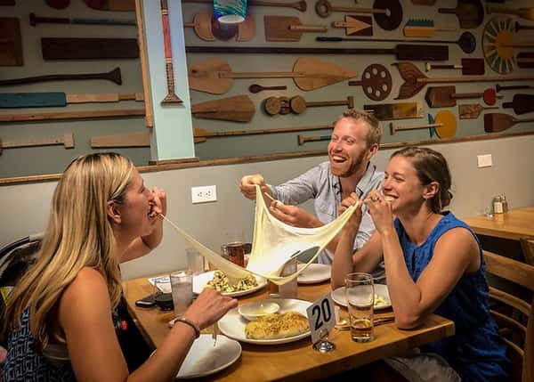 People eating enjoy Wood Paddle food and drinks
