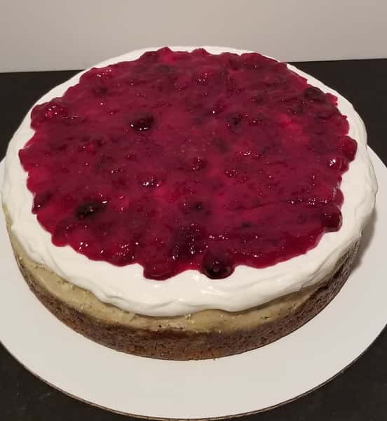 Eggnog cheesecake w/ triple berry sauce topping