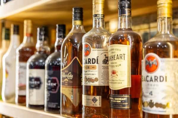 Bacardi and spiced rum bottles displayed behind the bar at Tijuana Joe's, offering premium spirits for margaritas and cocktails.