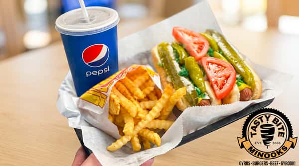 Hot dog with tomatoes and pickles, crinkle-cut fries, and a Pepsi.
