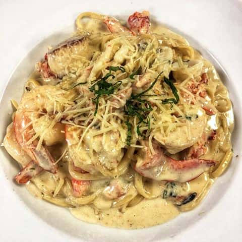 Lobster ravioli with lobster claw and shaved paremsan cheese