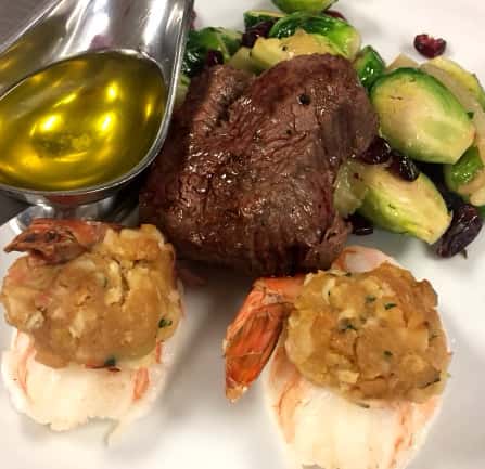 Steak with brussel sprouts, lobster tail, and melted butter