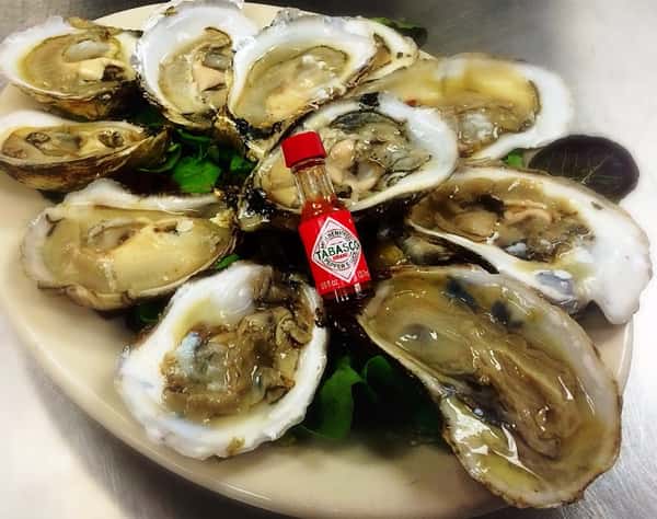Raw oysters with mini bottle of tabasco