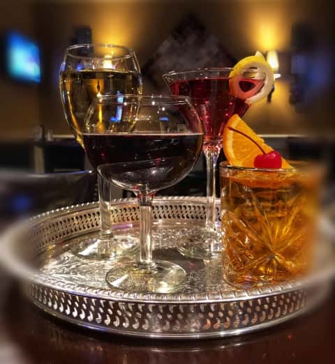 Metal tray with four classes of wine