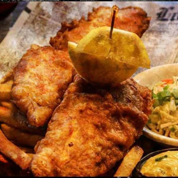 2 chicken tenders. one with a toothpick through the lemon and chicken