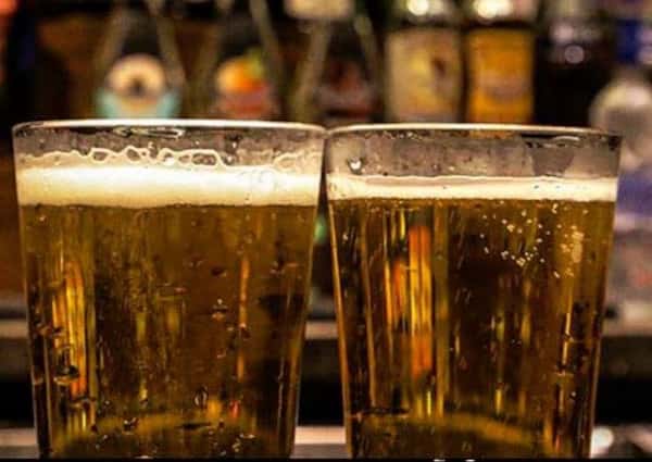 two beers in a glass cup