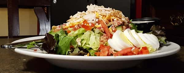 a salad with lettuce, tomato, boiled eggs and cheese