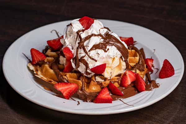 Dessert with chocolate, waffle and strawberries