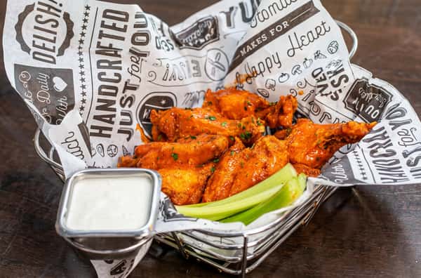 Buffalo wings with celery and dipping sauce