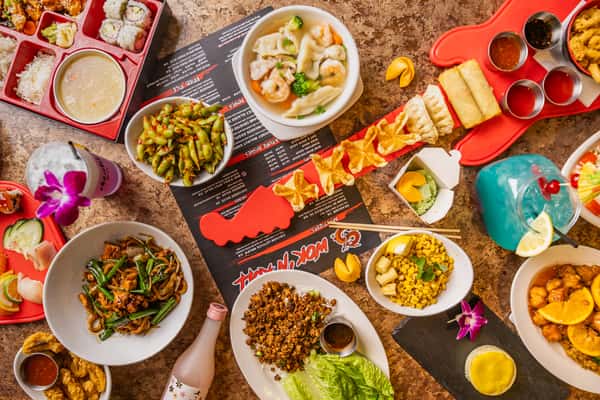 Vibrant Asian fusion feast with lo mein, dumpling soup, edamame, lettuce wraps, fried appetizers, sushi, and colorful cocktails.