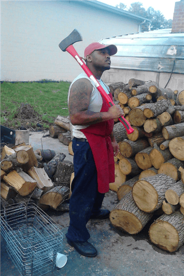 pitmaster outside gathering wood for the smoker