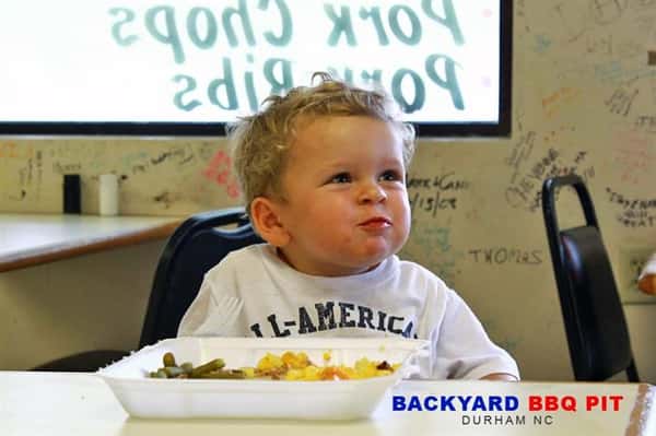 child eating with his cheeks stuffed with food