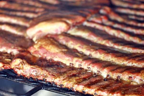 multiple racks of ribs laid in the smoker