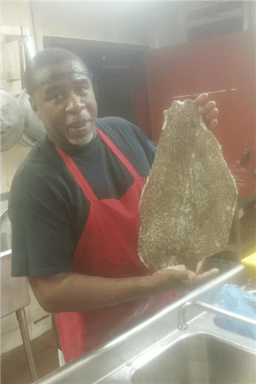chef holding up a large fillet of fish