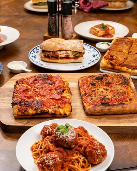 This is what a proper feast looks like. ✨ Pizza, pasta, sandwiches — all made from scratch and ready to share. Pull up a seat and make a night of it. We'll handle the rest.