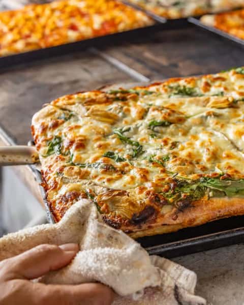 Fresh out of the oven and ready for you. 🍕 Every Roman pan pizza at Teglia is made from scratch — dough, sauce, and toppings, all done right.