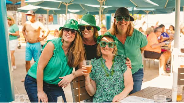 Group of people celebrating St. Patrick's Day at Lucky Fish Beach Bar