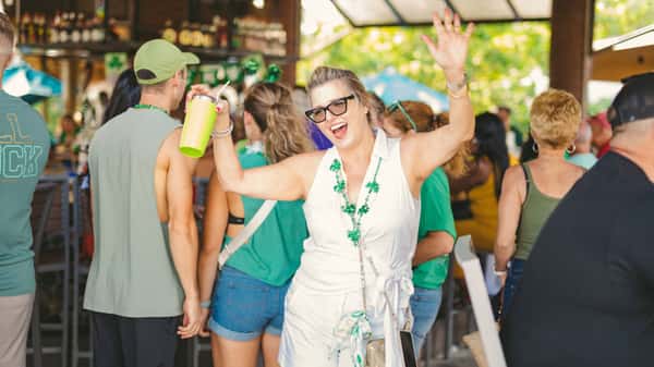 Woman dancing and celebrating St. Patrick's Day at Lucky Fish
