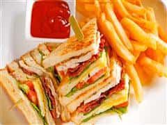 Turkey Club sandwich with french fries and side ketchup