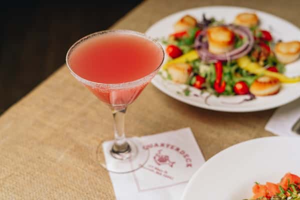 grapefruit martini with scallop salad in background