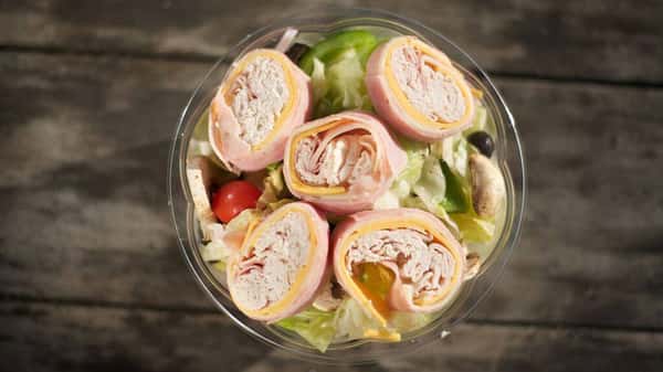 assortment of ham, cheese wrapped in a salad with lettuce, and tomatoes