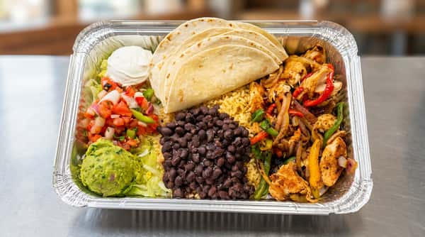 Ingredients for Chicken Fajitas in an aluminum container
