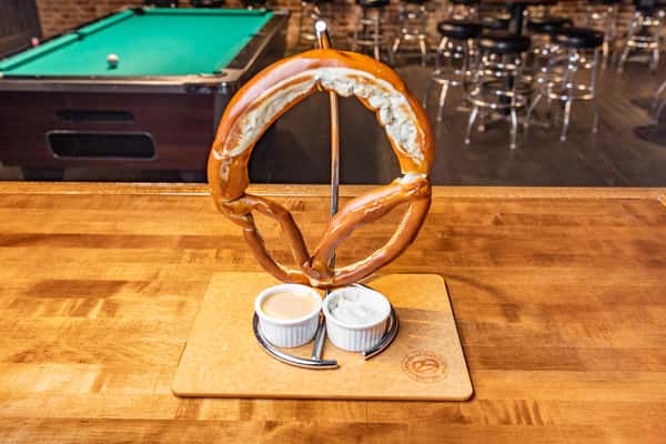 large pretzel with sauce