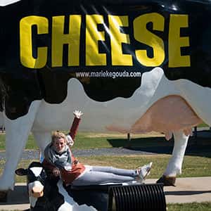 marieke in front of cow statue with cheese text