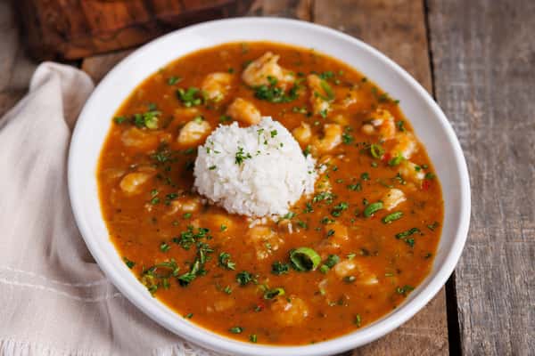 Shrimp gumbo with white rice and fresh herbs in a rich, flavorful broth, Southern comfort food dish