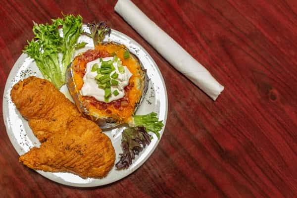 Crispy fried fish fillets served with a loaded baked potato topped with cheese, bacon, sour cream, and green onions.