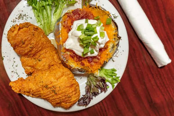 Crispy fried fish fillets served with a loaded baked potato topped with cheese, bacon, sour cream, and green onions.