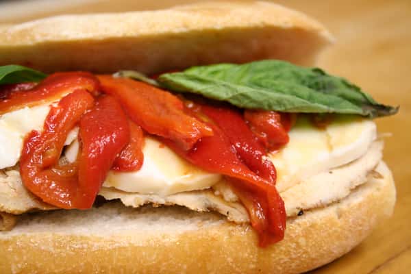 Sandwich with red peppers, chicken, and basil