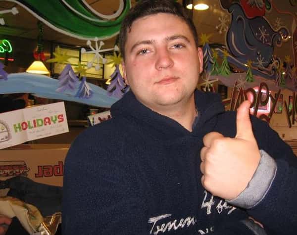 Man posing for a picture giving thumbs up