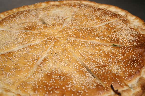 Stuffed pizza with sesame seed crust