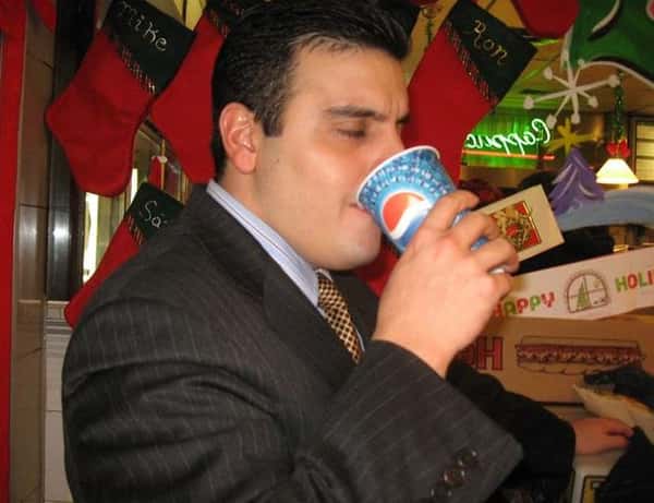 Man drinking soda out of a Pepsi cup