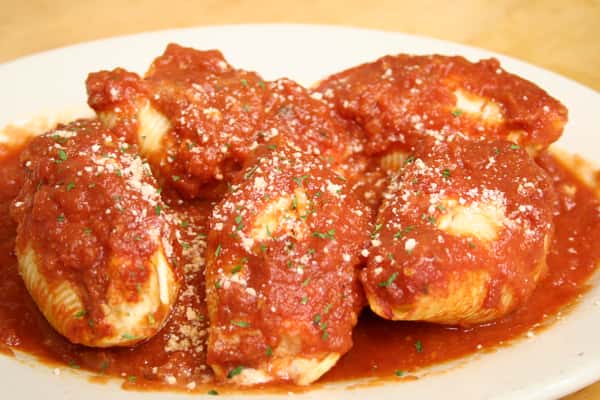 Stuffed shells topped with red sauce